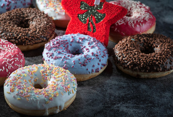 Donuts with New Year Ornaments. presented on black marble