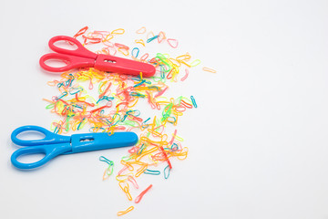 Scissors and Rubber band on white background