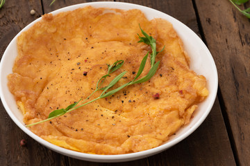 Omelette or egg fired on white plate