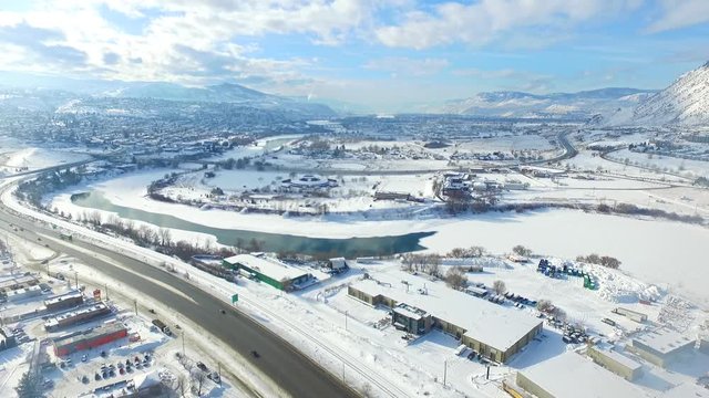 Beautiful canadian winter - city and mountains covered in snow shot from drone