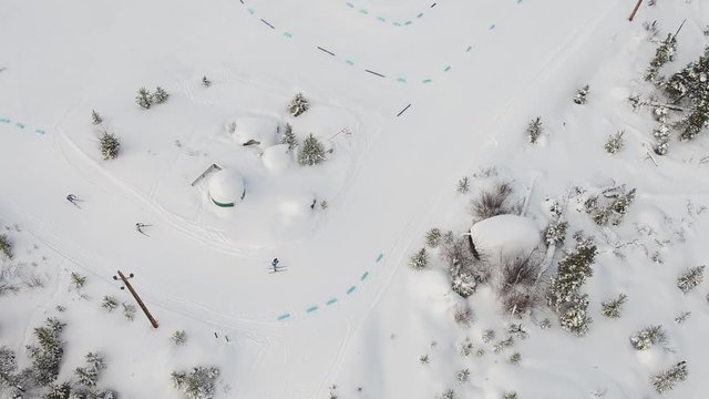 tracking aerial shot of cross country skiers racing for the finish line in winter games track