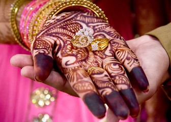 Gold wedding rings are on the bride's hand