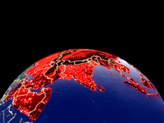 Asia from space on planet Earth at night with bright city lights. Detailed plastic planet surface with real mountains.