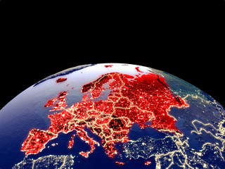 Europe from space on planet Earth at night with bright city lights. Detailed plastic planet surface with real mountains.