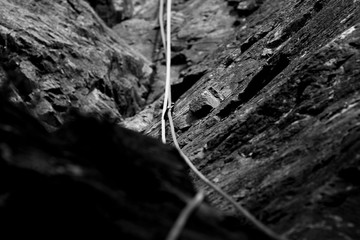 Black and white of climbing rope and carabiner (karabiner) on rock climbing in the Lake District, Cumbria