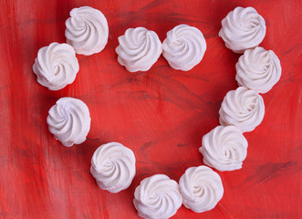 Light and airy marshmallows on a coral-colored background.Fashionable color coral - 2019.painted in the fashionable color of 2019