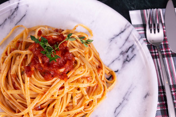 Delicious spaghetti served on a marble plate