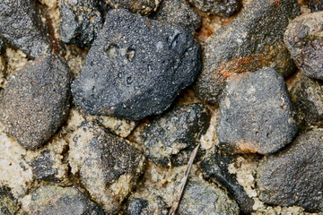 black stone on wet sand