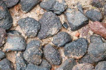 black stone on wet sand