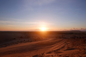 Fototapeta na wymiar Sunrise in desert, white sand dune in Mui Ne, Vietnam Southeast Asia