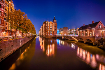 The Warehouse District (German: Speicherstadt) in Hamburg, Germany at night.  The largest warehouse district in the world is located in the port of Hamburg within the HafenCity quarter.