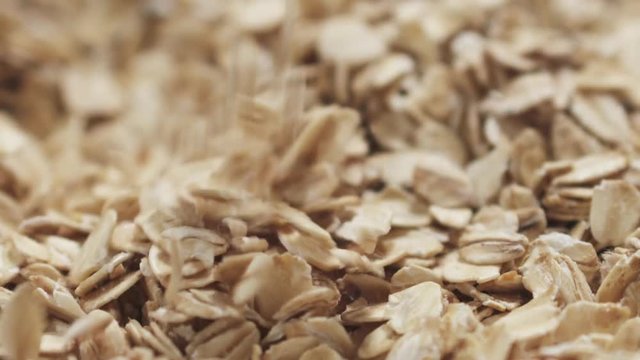 Slow motion closeup falling oat flakes