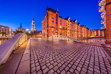 The Warehouse District (German: Speicherstadt) in Hamburg, Germany at night.  The largest warehouse district in the world is located in the port of Hamburg within the HafenCity quarter.