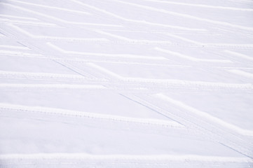 Traces of intersecting arcs of automobile tires in fresh snow