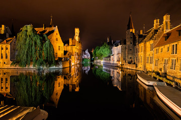 Fototapeta premium Bruges, Belgium, at night with its historic old town and canals illuminated.