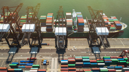 Aerial footage commercial logistics industry. The containers is loaded / unloaded at Kwai Tsing...