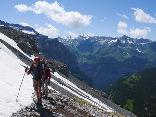 mountain climbers heading to the foot of Eiger and Moench mountain peaks in the Swiss Alps near Grindelwald