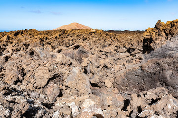 Lava field and tourist road trail to vulcano Caldera Blanca, Lanzarote, Canary Islands, Spain