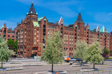 Fototapeta premium View of the Warehouse district (German: Speicherstadt) and the The Dar-es-Salaam square on a sunny day in Hamburg, Germany.