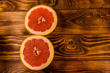 Fototapeta na wymiar Ripe juicy grapefruit on a wooden table. Top view