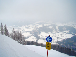 Attention sign blue slope runway on a wintersport track