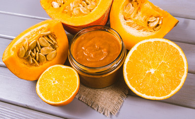 Homemade preserves. Pumpkin jam on a wooden background.