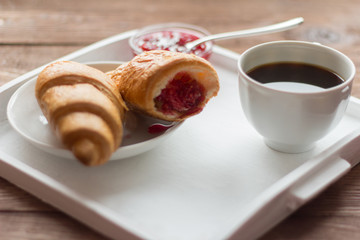 rustic Breakfast with croissants, black coffee and jam