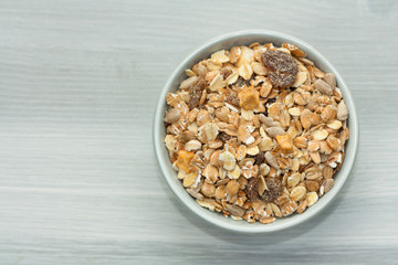 Bowl of muesli on wooden backgound.