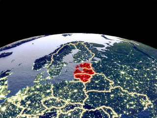 Baltic States from space on planet Earth at night with bright city lights. Detailed plastic planet surface with real mountains.