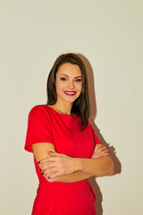 Obraz premium Portrait of beautiful smiling woman looking at camera over white background.