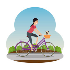 woman in retro bicycle with basket and dog on the road