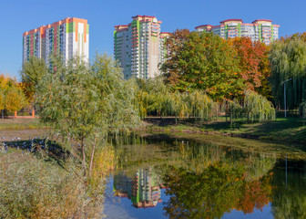 Residential area on the shore of the summer lake. Reflection of colorful houses to water
