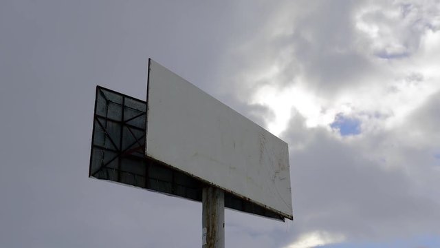  Empty billboard sign against storm clouds on blue sky at winter, timelapse footage.