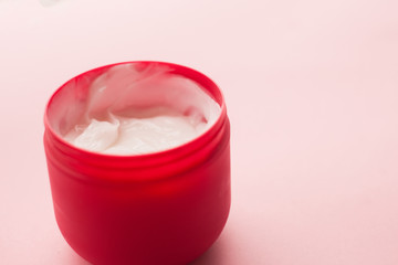cosmetic for body, face, hair. face cream in a jar. hair mask. skin care. on a pink background. selective focus.