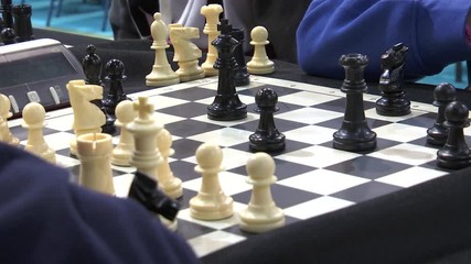 CHILDREN’S HAND PLAYING CHESS KING EATING BISHOP