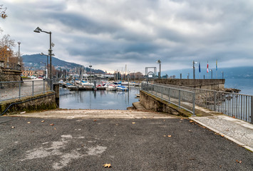 New Harbor of Luino on the Lake Maggiore in cloudy day, province of Varese, Italy