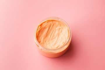 cosmetic for body, face, hair. face cream in a jar. hair mask. skin care. on a pink background. selective focus.