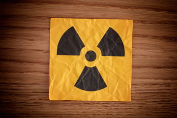 Radiation warning sign on a wooden board