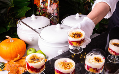 Cookies, berry syrup, peaches and mousse, are served in a glass