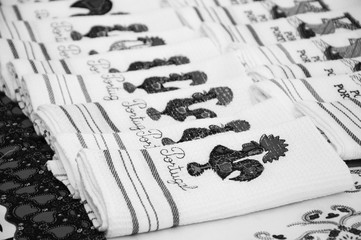 Souvenir towels with embroidery of the Galo de Barcelos (Barcelos Rooster) - traditional symbol of Portugal - at the street market in Porto (Portugal). Black and white photo.