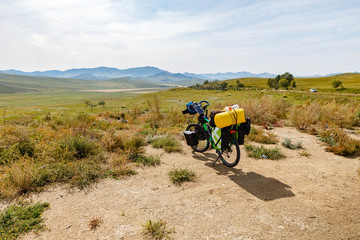 traveler's bike with bags, landscape in mongolia, Bike adventure travel, tourist bike