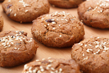 Obraz na płótnie Canvas Pattern of oatmeal cookies with dried berries and sesame. Selective focus.