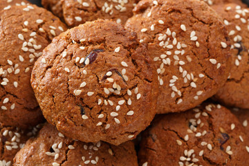 Pattern of oatmeal cookies with dried berries and sesame. View from above. Selective focus.