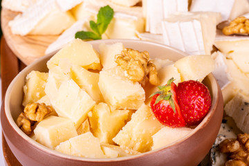 The parmesan cut on pieces with strawberry and walnut
