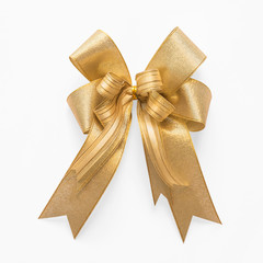 Gold bow ribbon satin golden fabric (isolated on white background with clipping path) for Christmas...