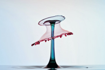 umbrella like water sculpture created by differently colored water drops