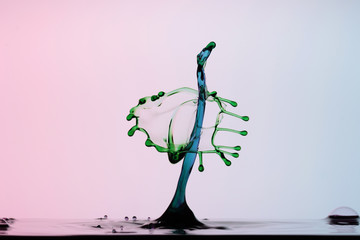 blue water column colliding with green drop