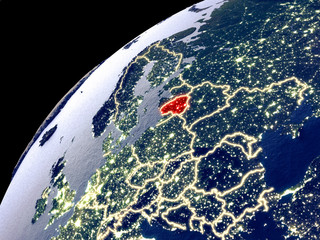 Satellite view of Lithuania on Earth with city lights. Extremely detailed plastic planet surface with real mountains.