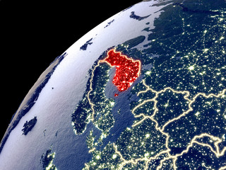Satellite view of Finland on Earth with city lights. Extremely detailed plastic planet surface with real mountains.