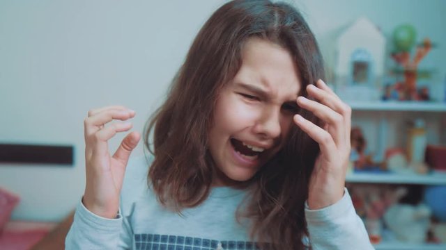 schoolgirl covering her face with her hands. emotion depression concept children. Shocked panic little girl screaming in despair and frustration. girl teenager screams opened her mouth lifestyle upset